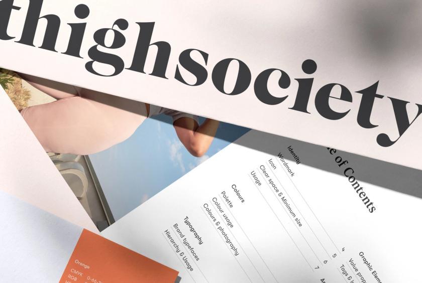 A close up of the inside pages of a brand guideline and the Thigh Society logo